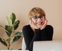 low view confident woman holding camera
