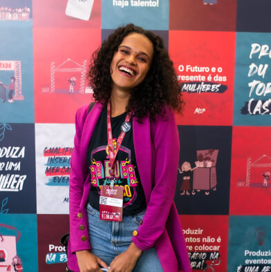 low view confident woman holding camera